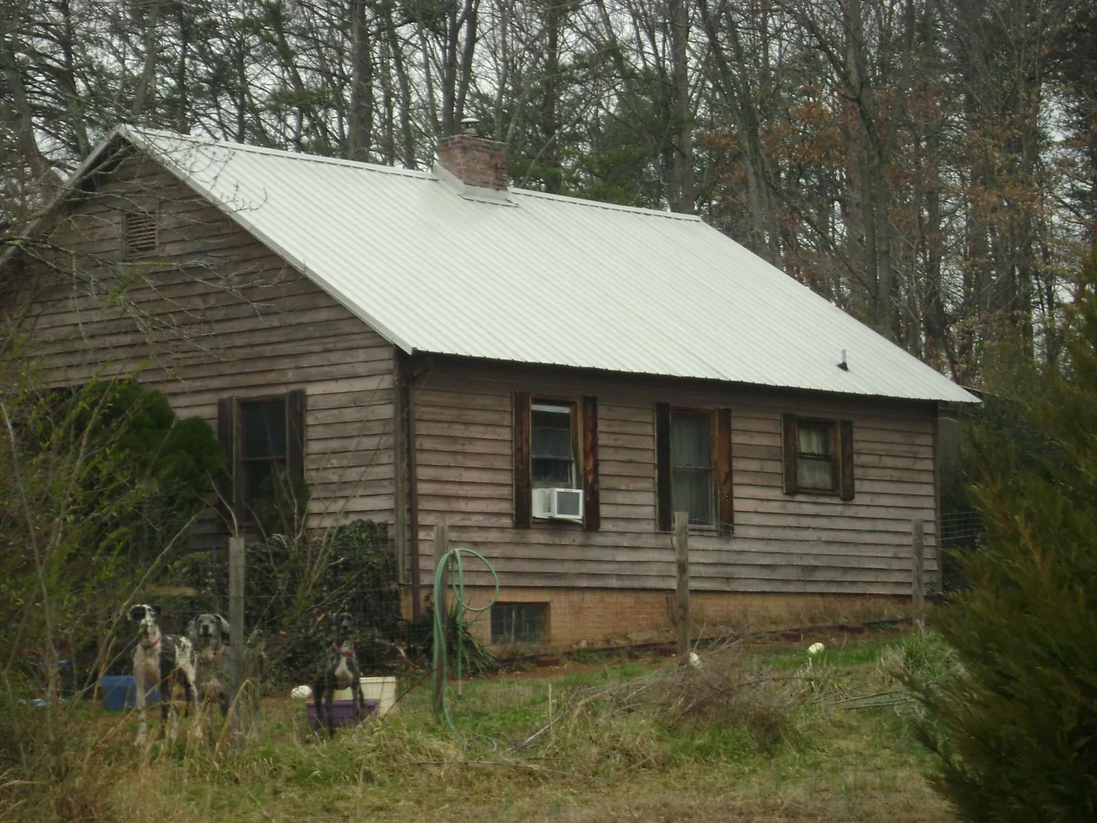 White metal roof on an old wood sided farmhouse, from a Metal Roof Installation job in Walstonburg